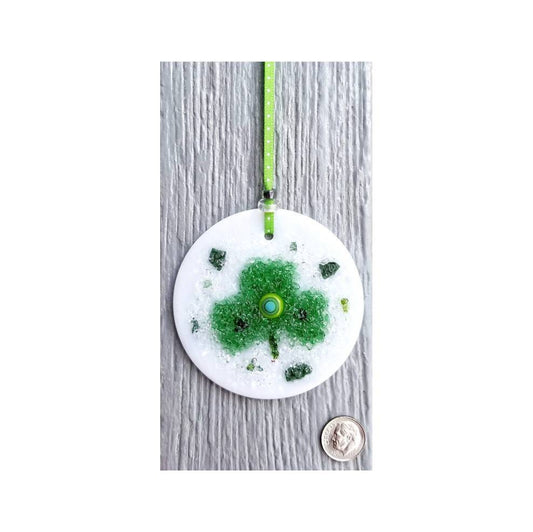 Shamrock Suncatcher Ornament. Green crushed glass is kiln fired & melted atop a 3"White Disc. Murrine center Detail with flecks of Dk. Green